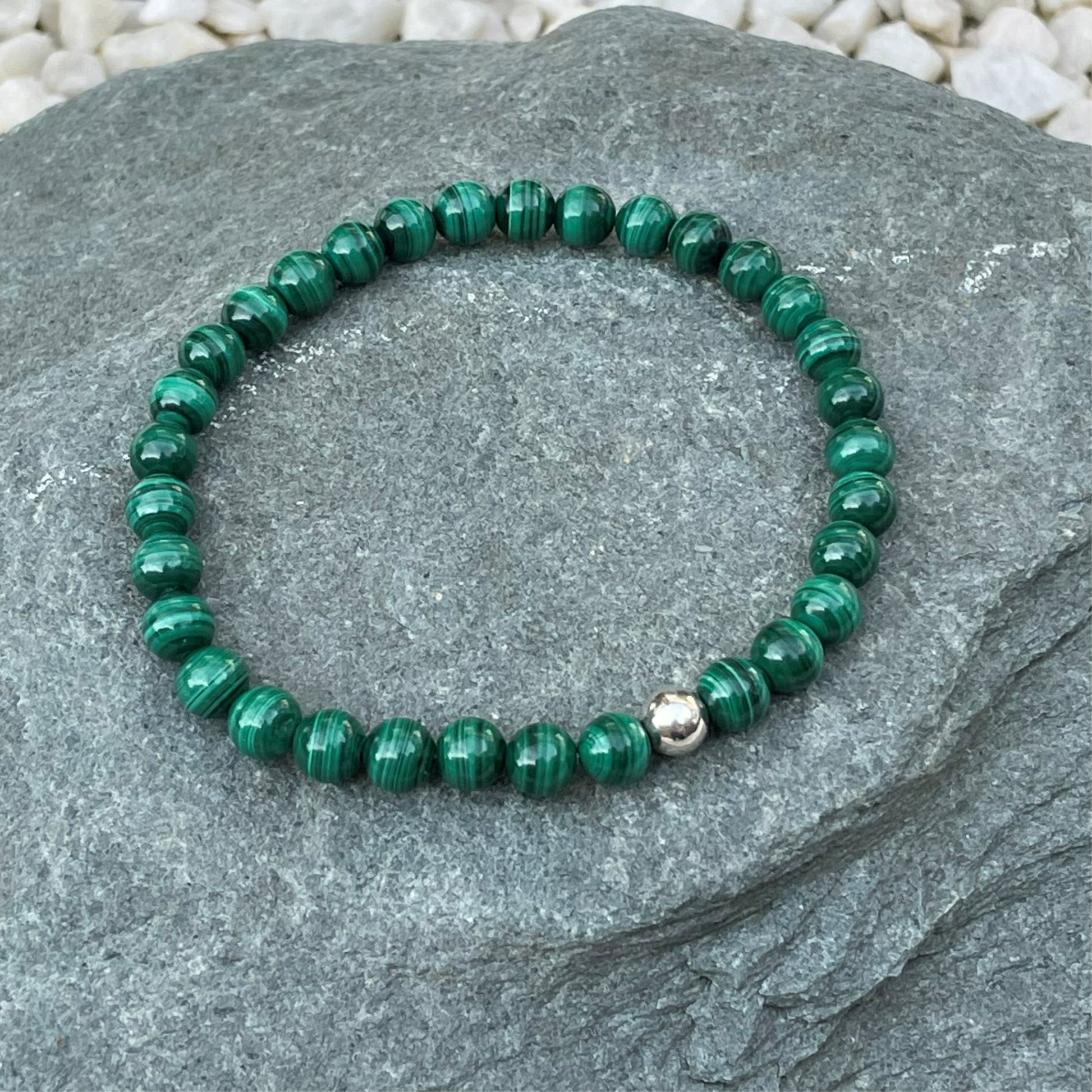 Green crystal bracelet on stone