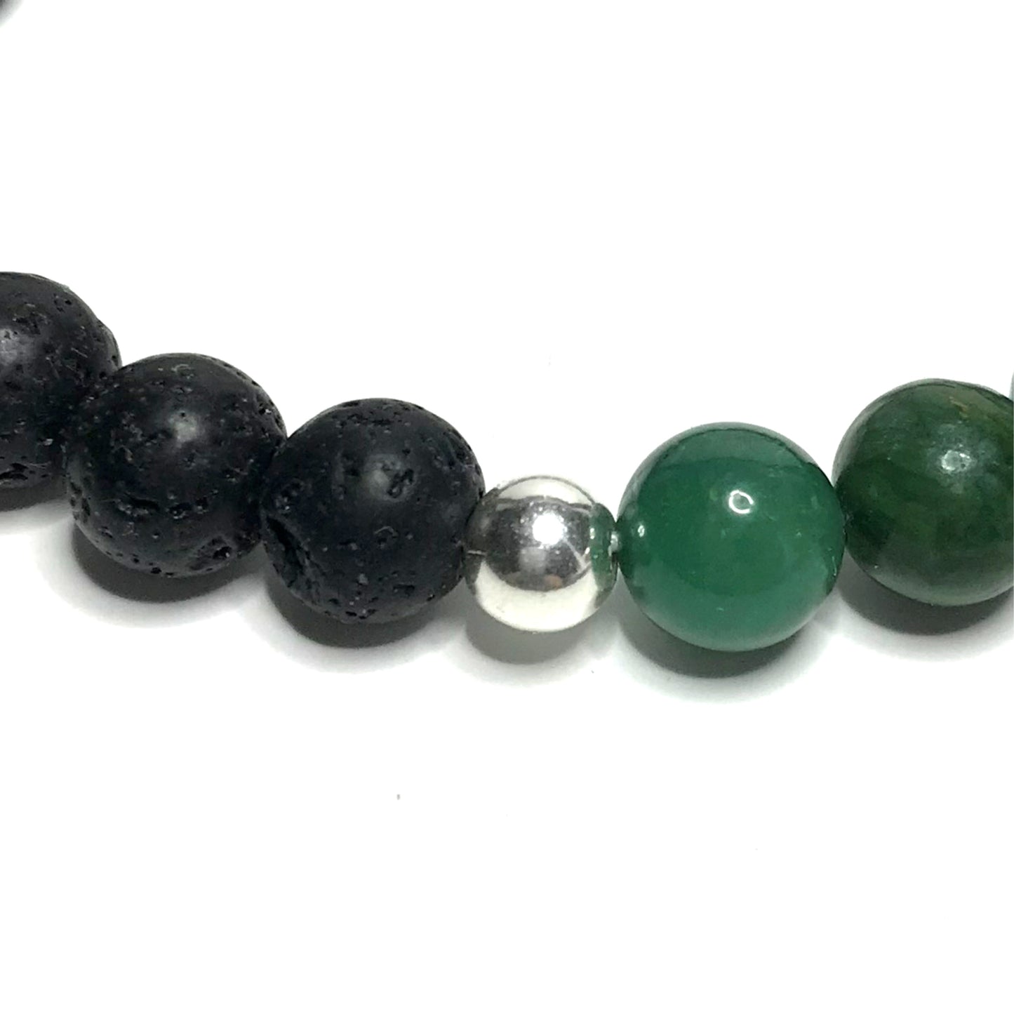Close up of sterling silver bead between lava and jade beads