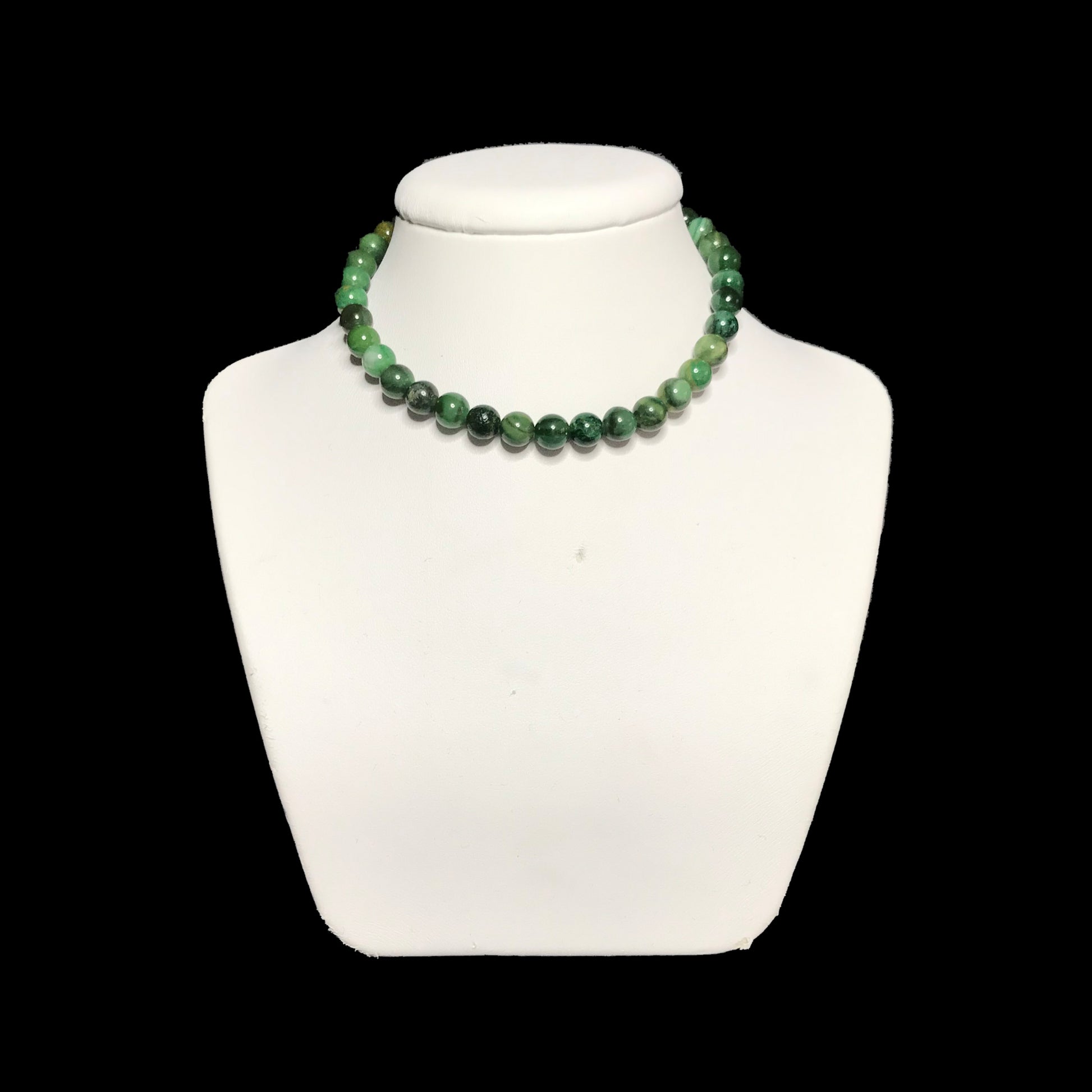 African jade choker on a white stand