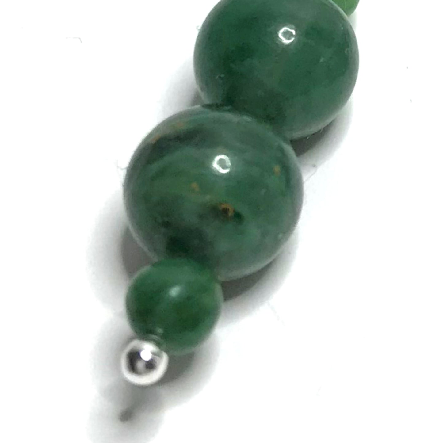 Close up of dark green crystal earring