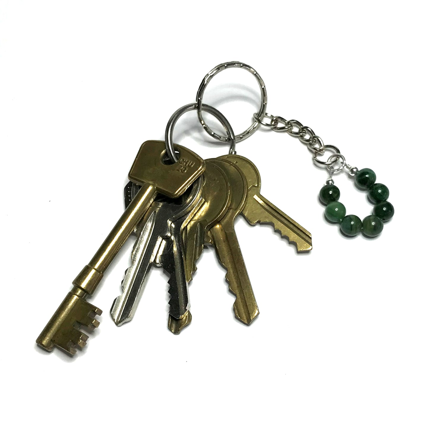 Dark green crystal bead keychain on a bunch of keys