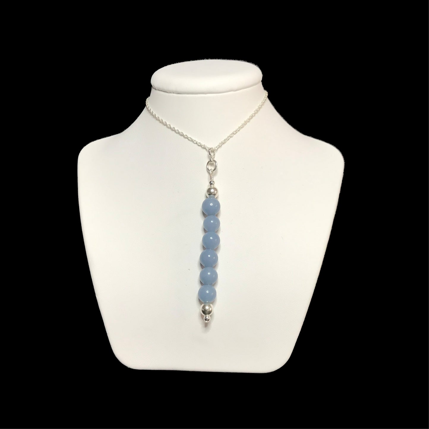 Beaded blue crystal pendant on white stand