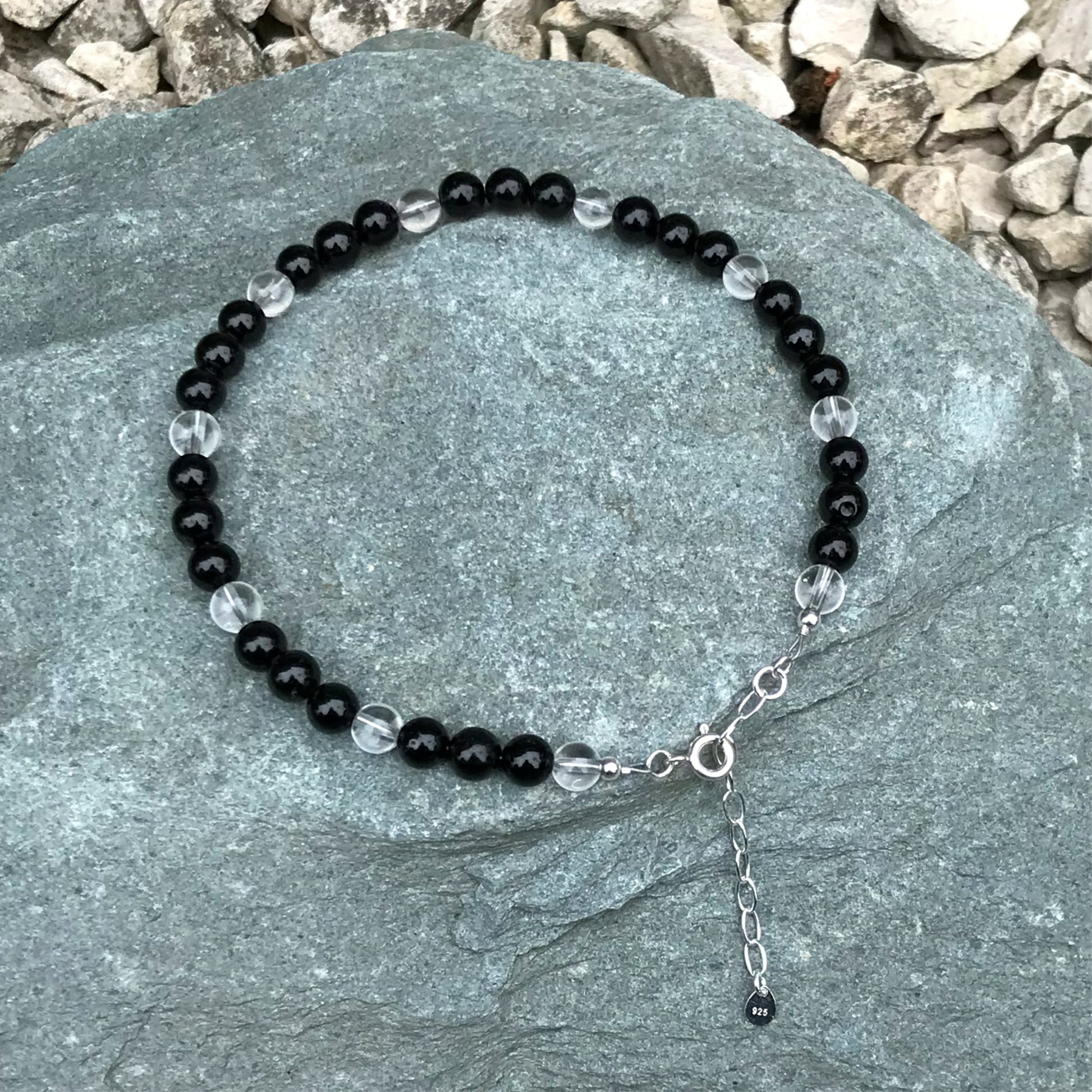 Black crystal anklet on stone