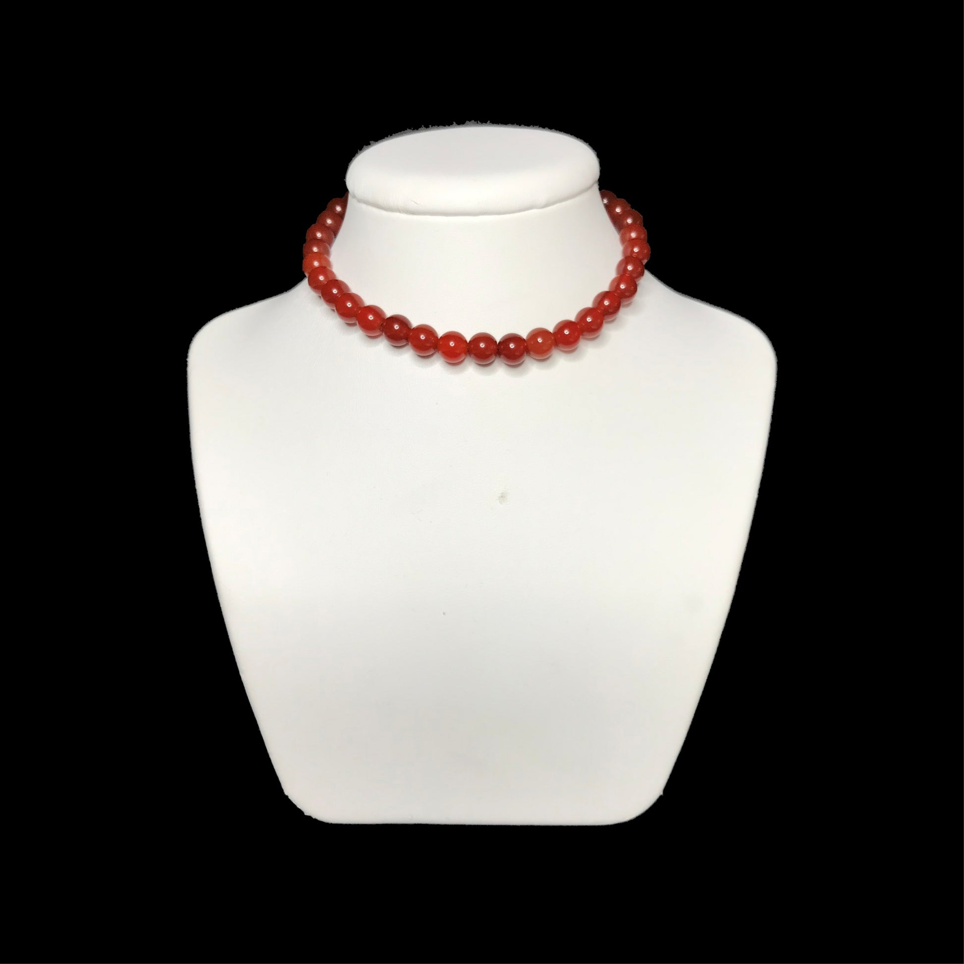 Carnelian beaded choker on stand