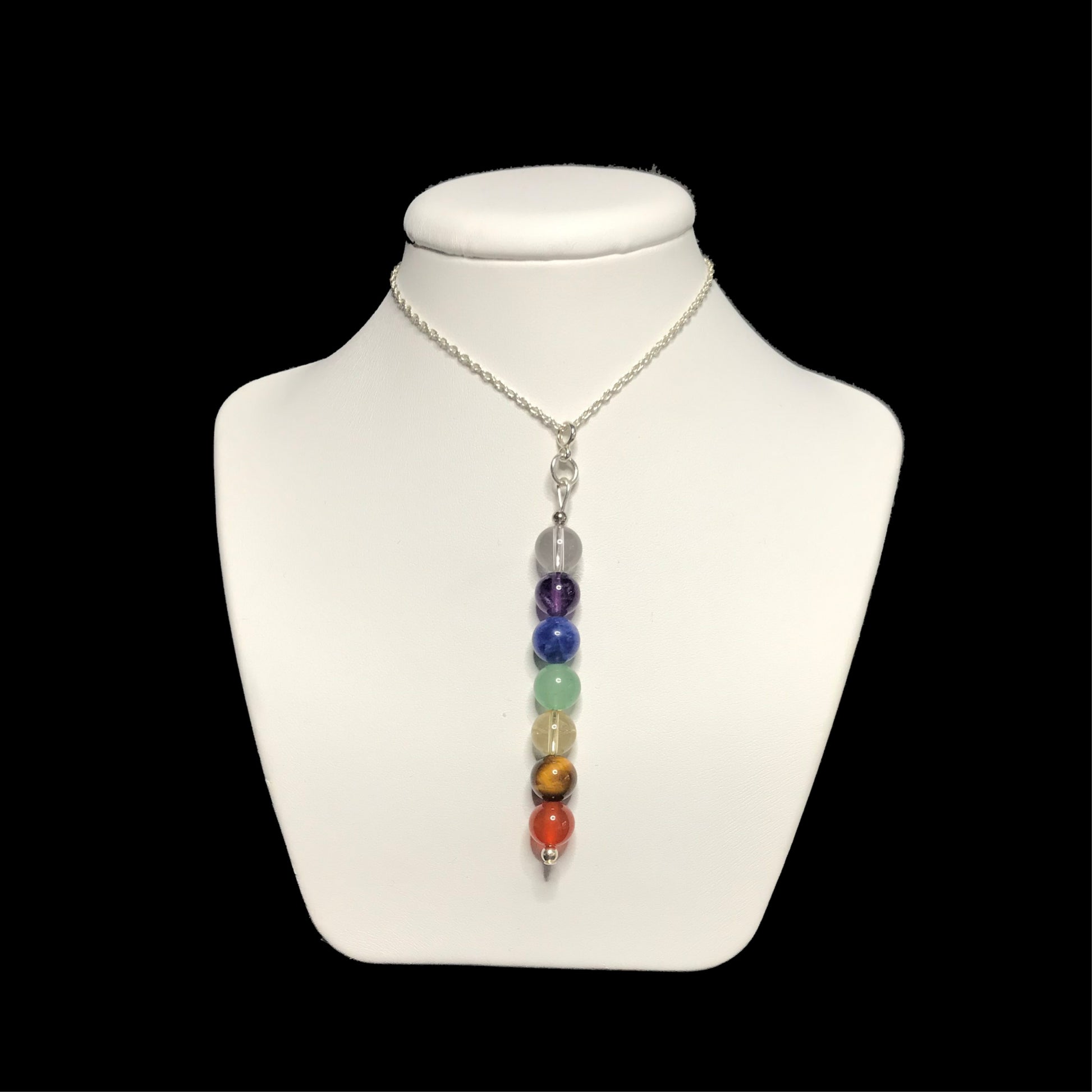 Chakra crystal pendant necklace on stand