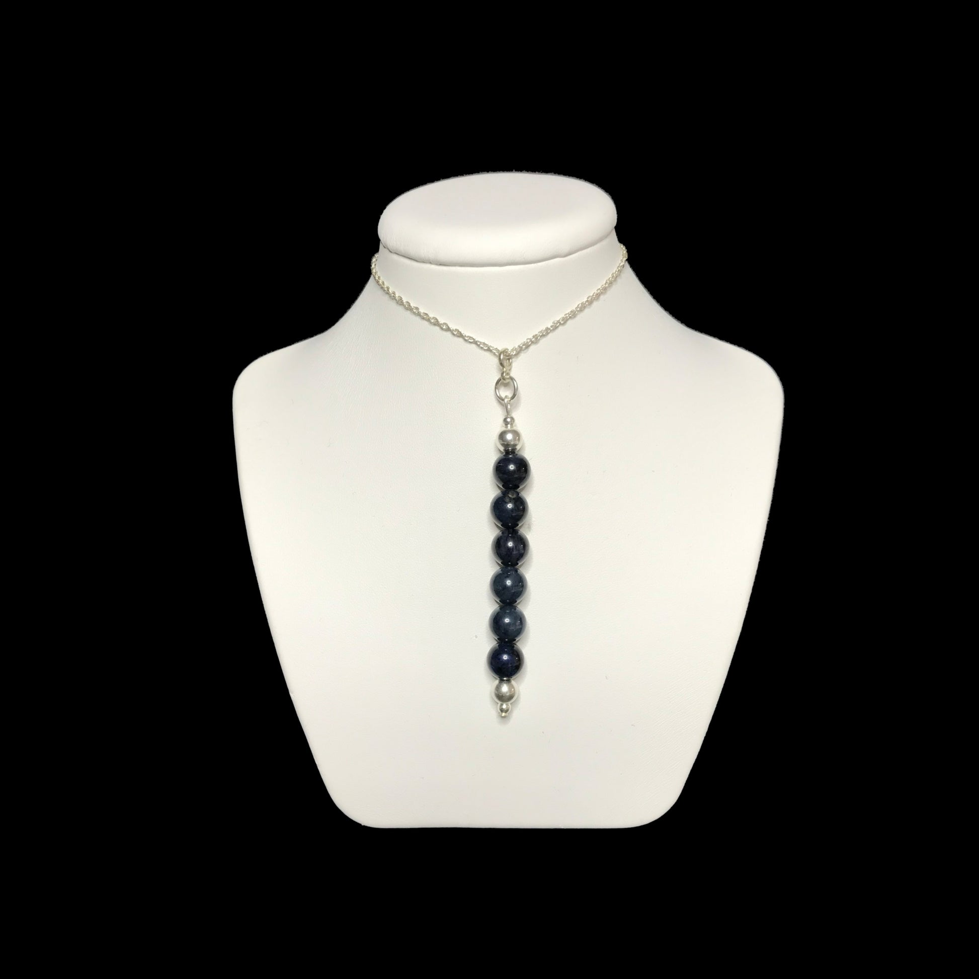 Dumortierite pendant necklace on stand