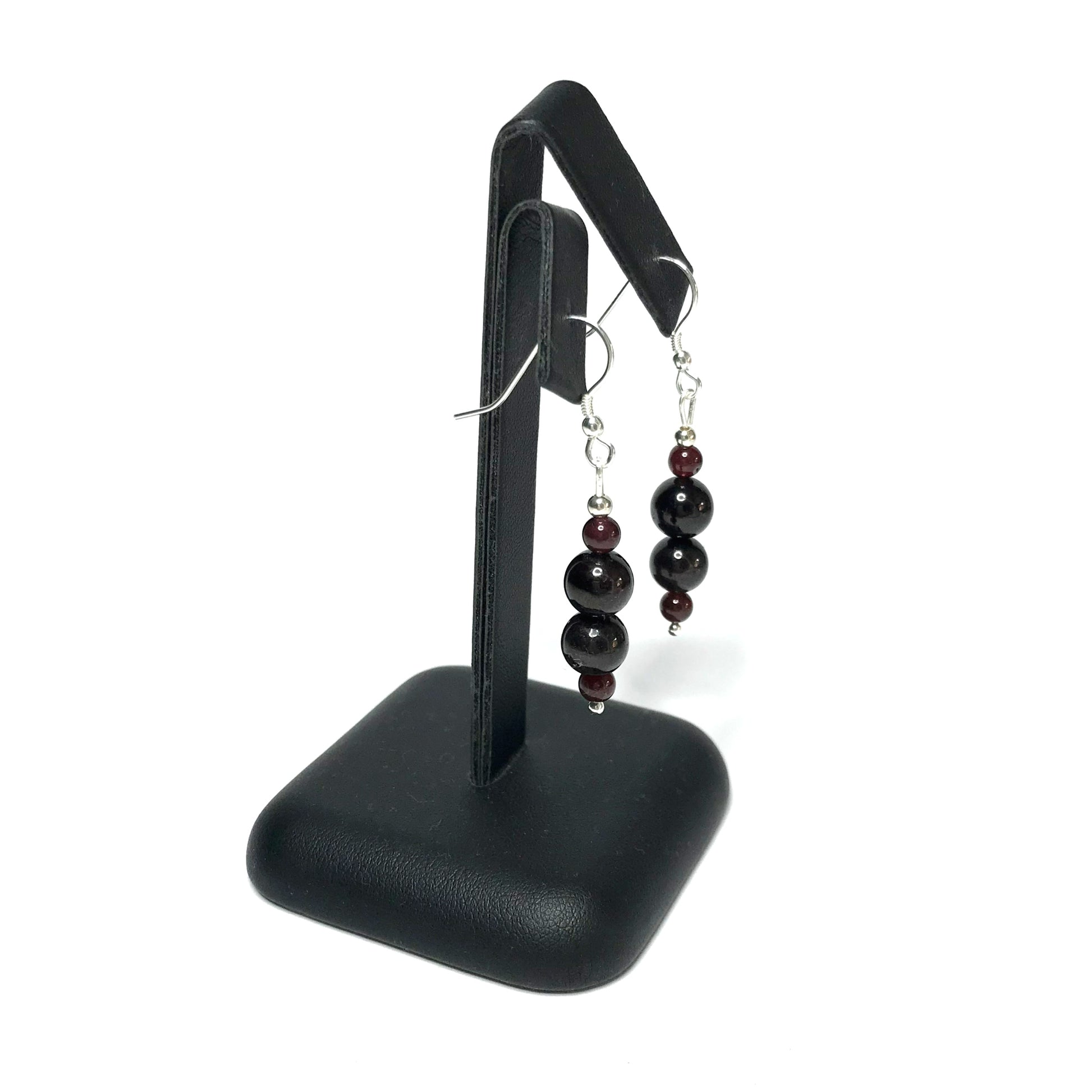 Garnet crystal earrings on stand