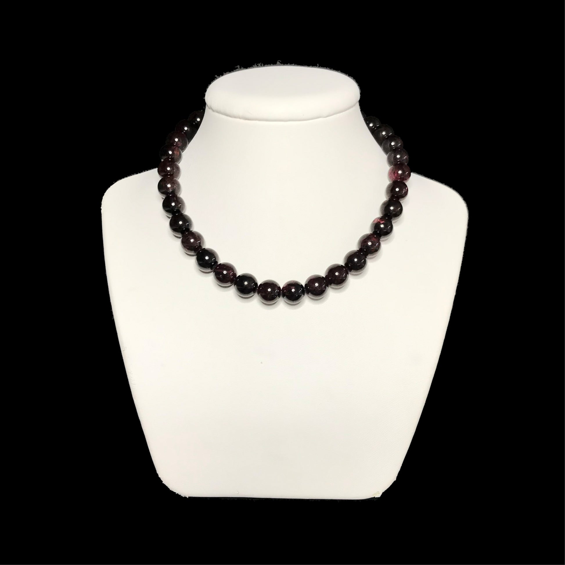 Garnet beaded necklace on stand