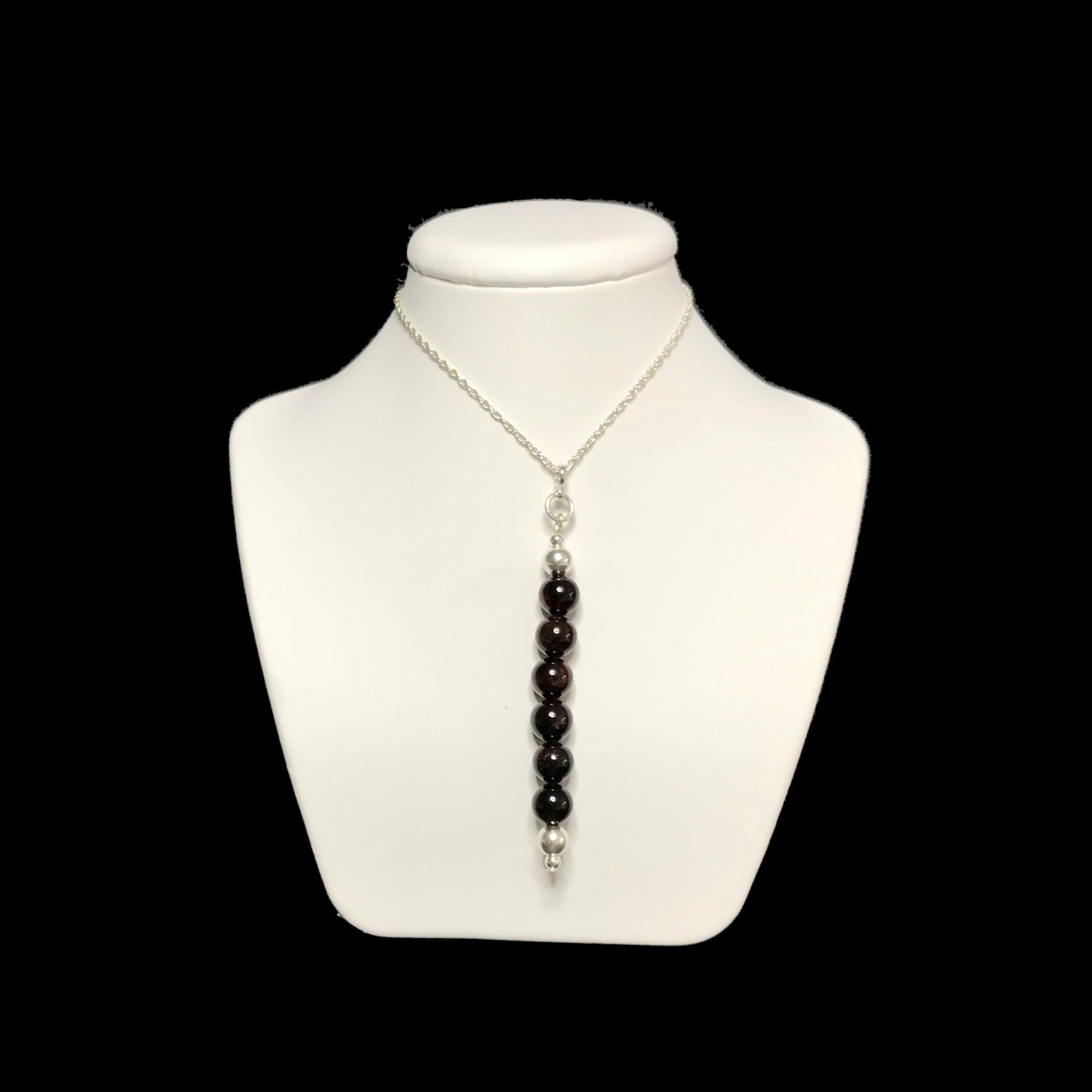 Garnet pendant necklace on stand