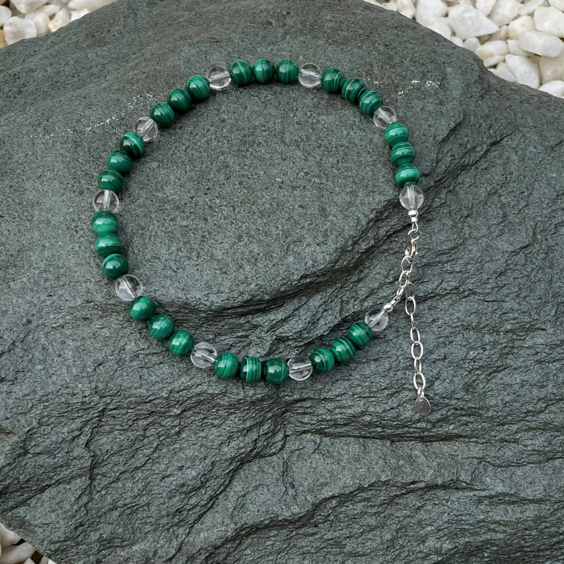 Green crystal anklet on stone