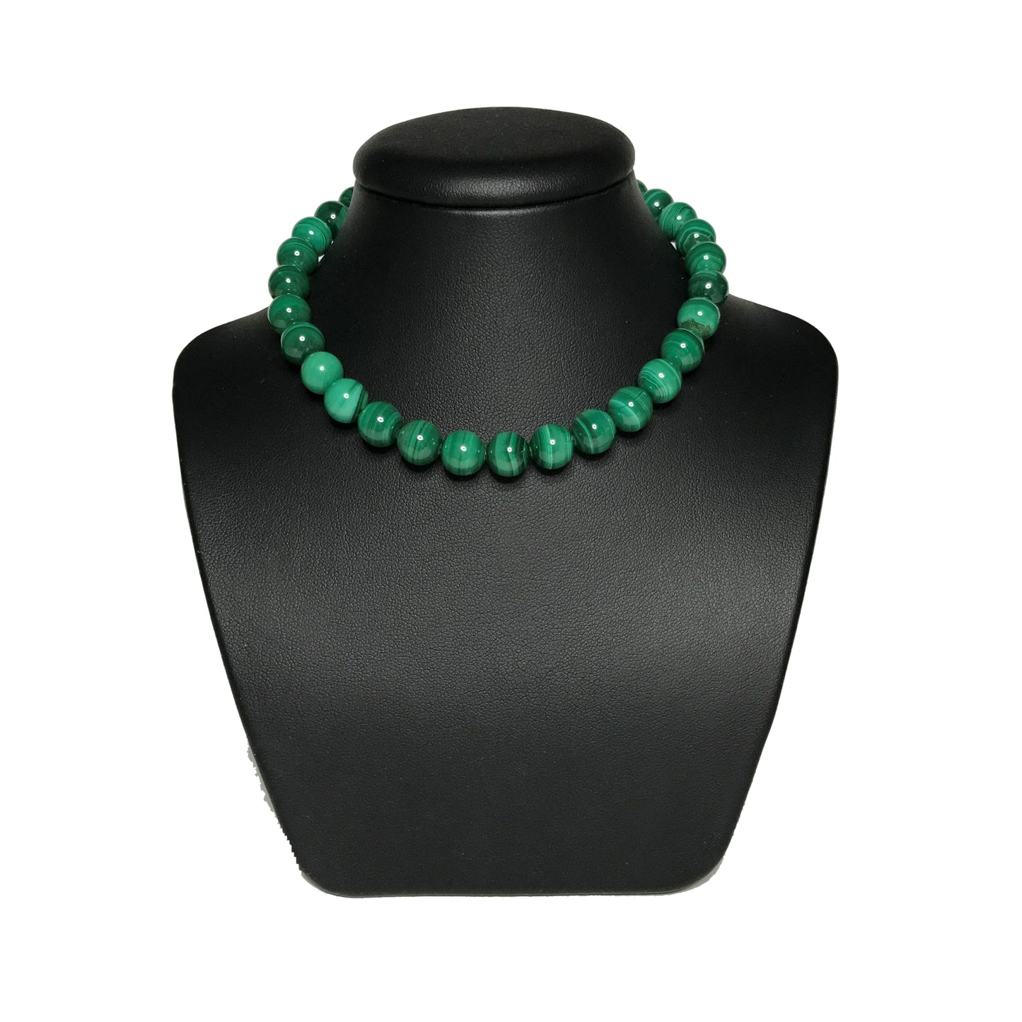 Green crystal beaded necklace on a black stand