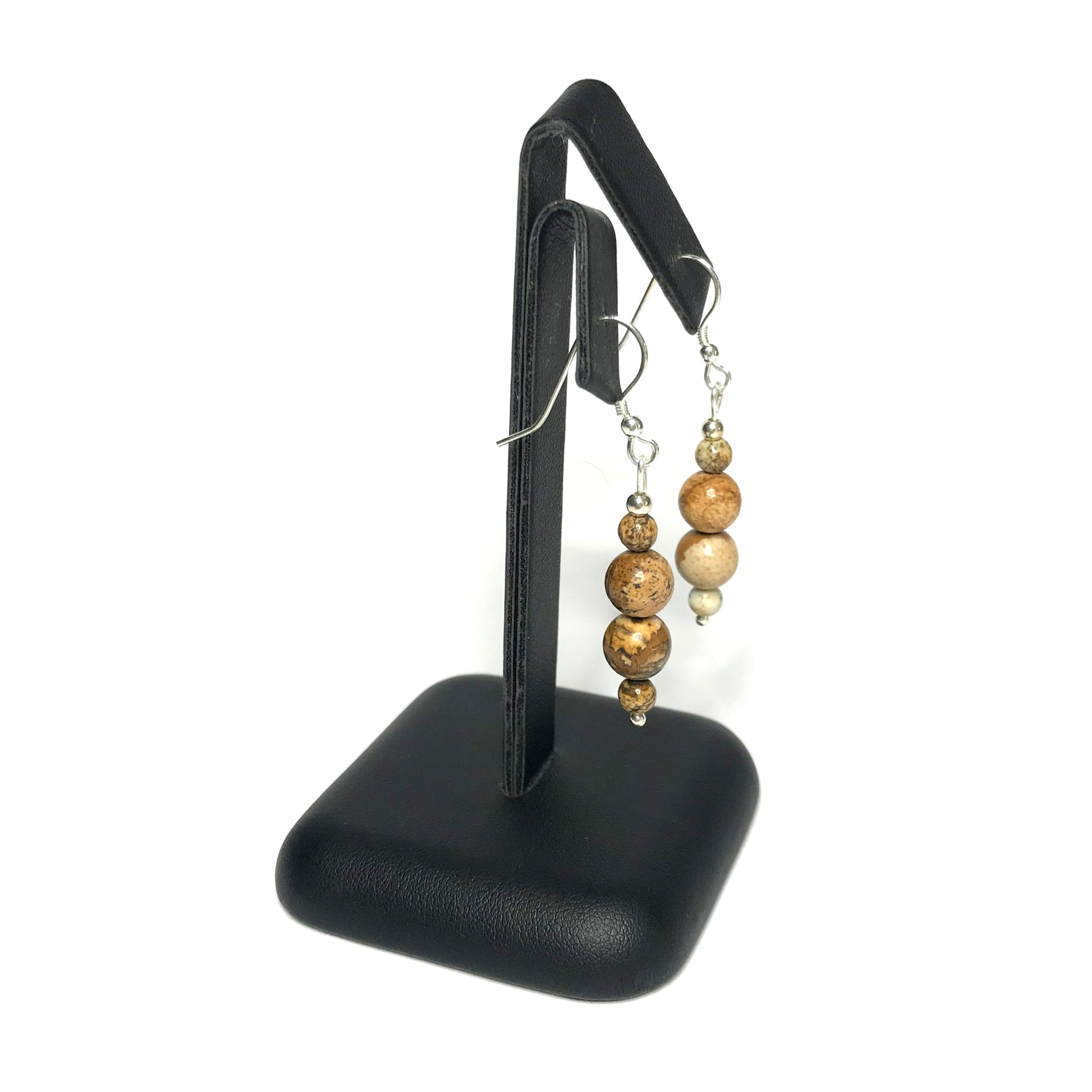 Picture jasper earrings on a stand