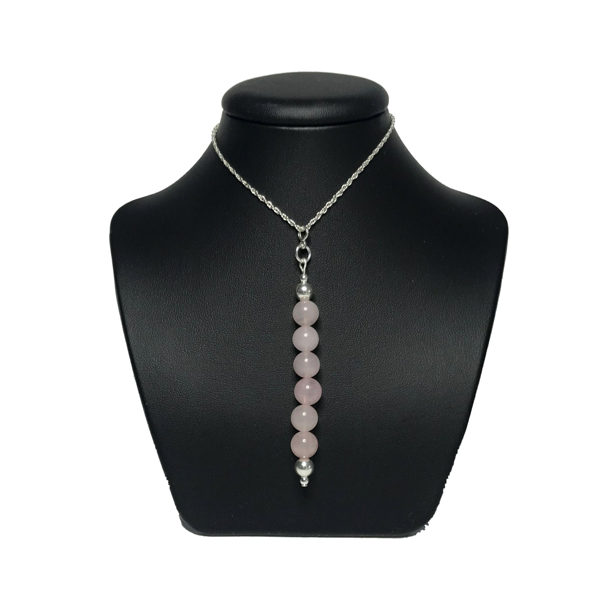 Rose quartz crystal pendant on stand