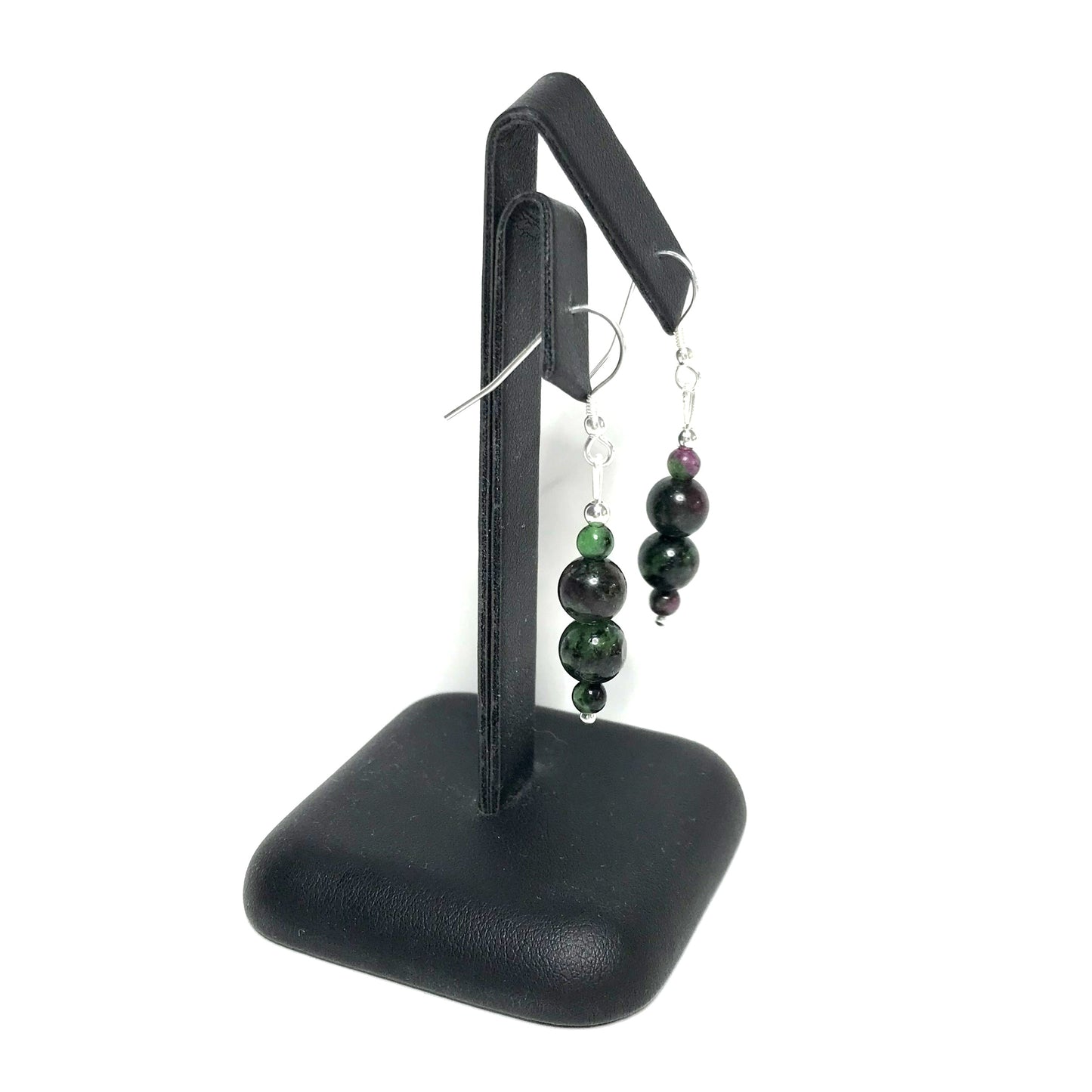 Ruby zoisite dangle earrings on stand