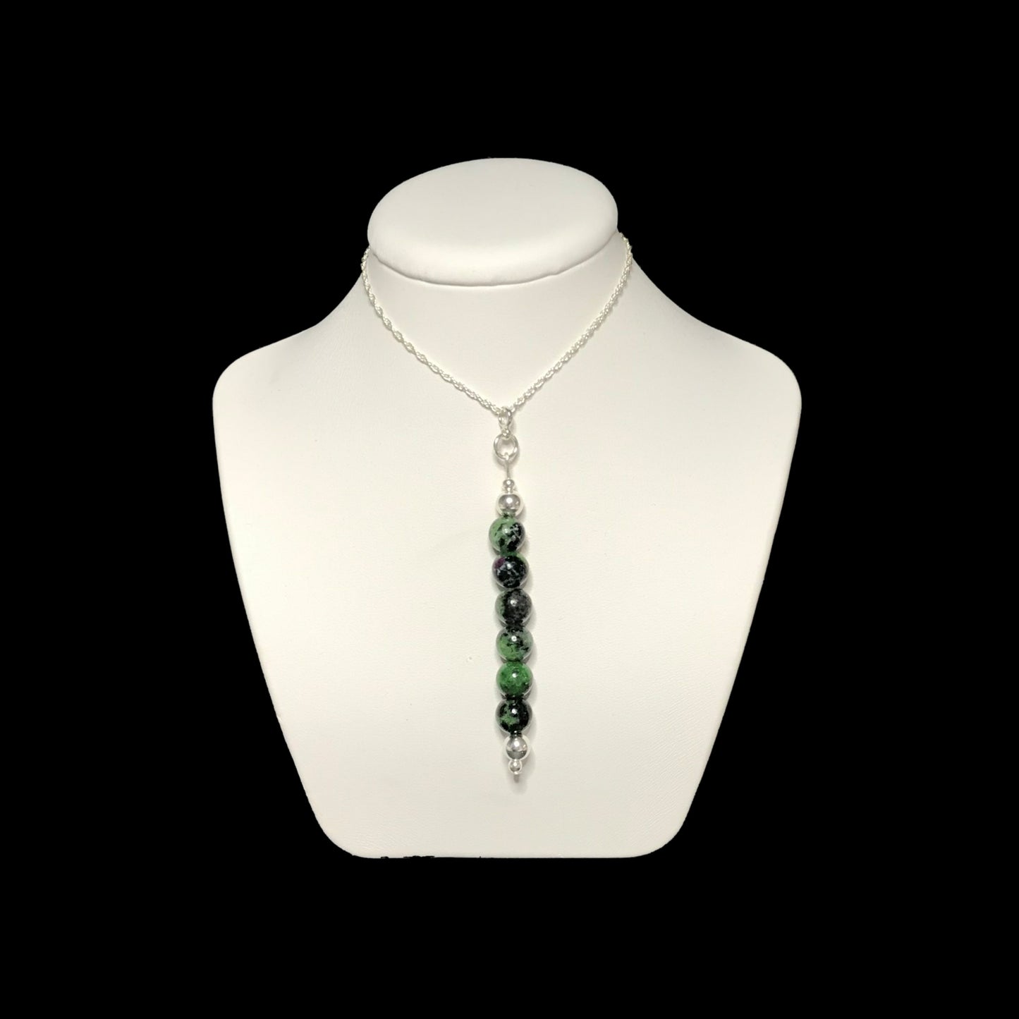 Ruby zoisite pendant necklace on stand