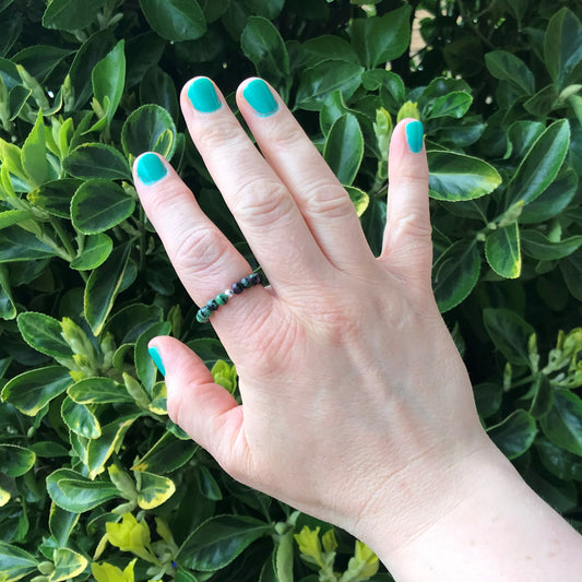 Hand wearing ruby zoisite stretch ring