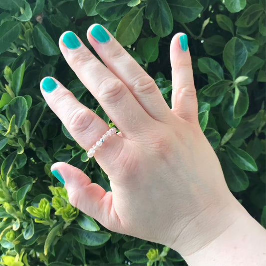 Hand wearing beaded sunstone ring