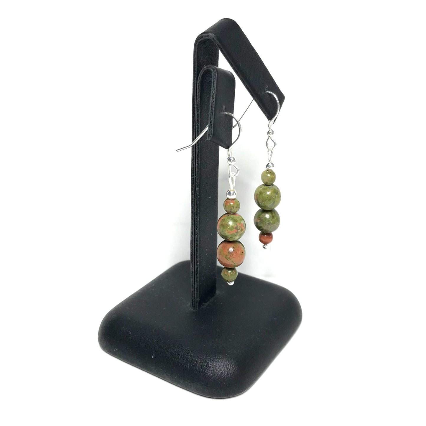 Unakite dangle earrings on a stand