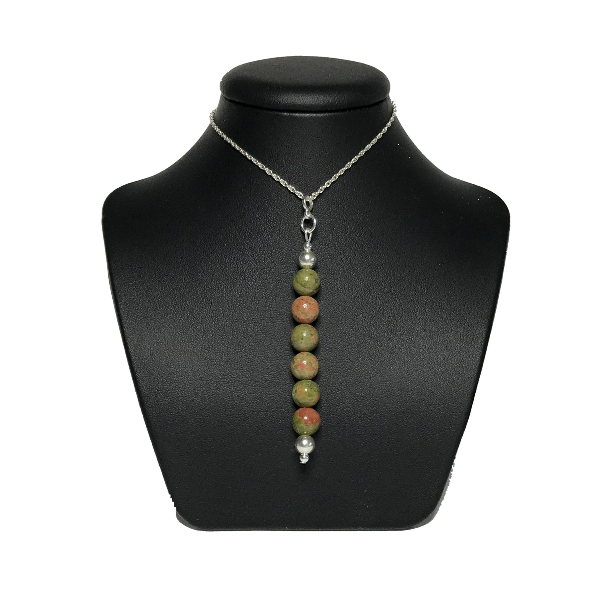 Unakite pendant necklace on a black stand