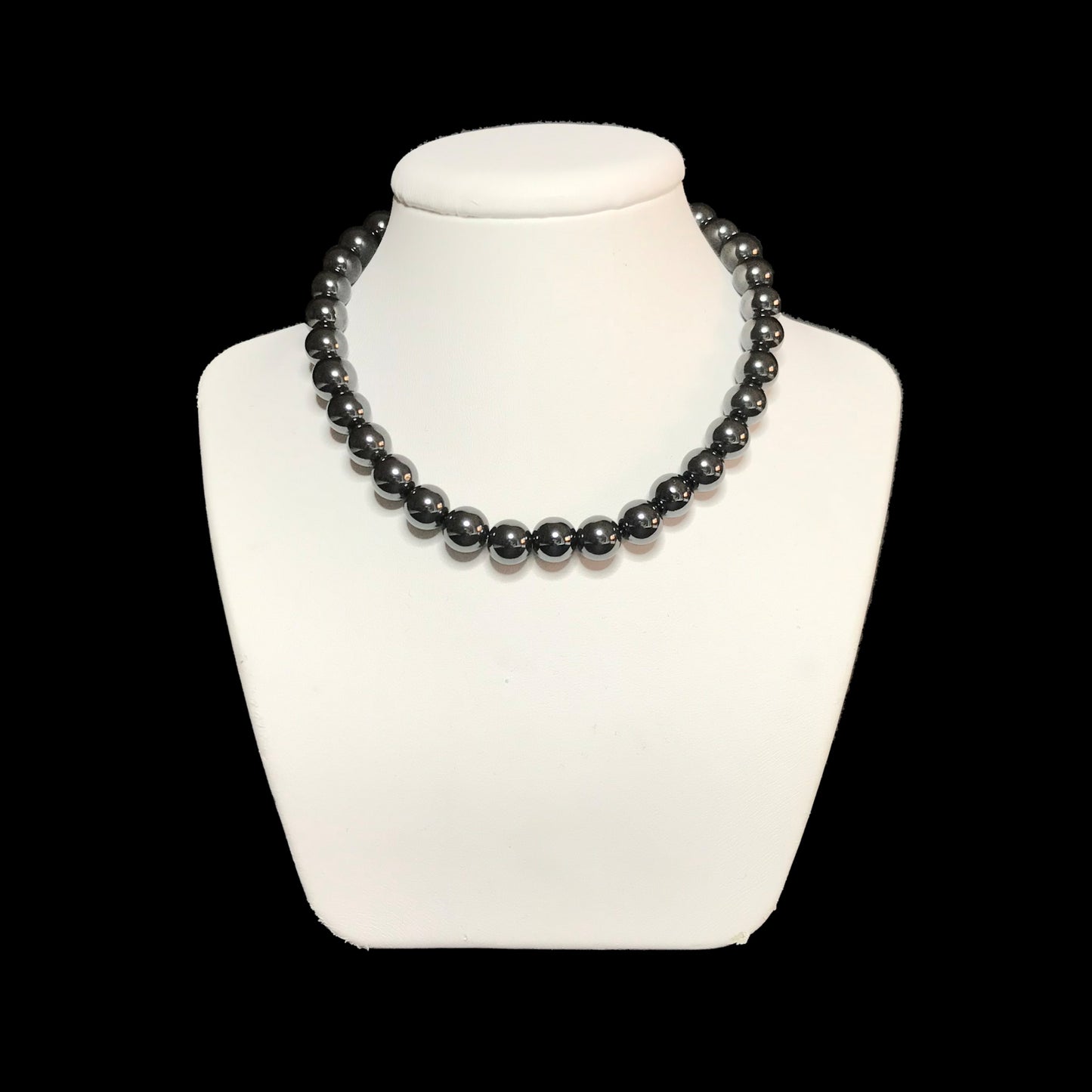 Hematite beaded necklace on stand