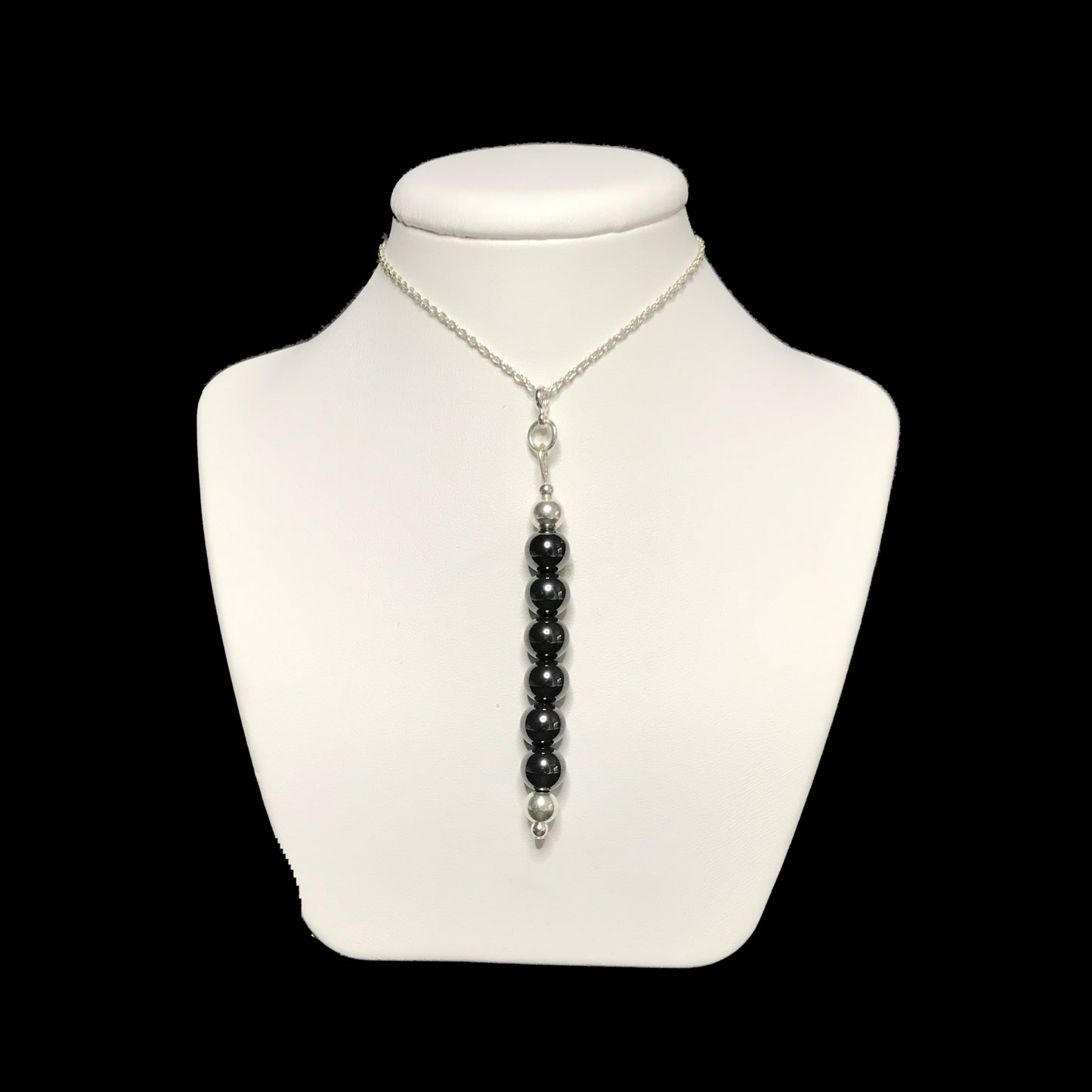 Hematite pendant necklace on stand