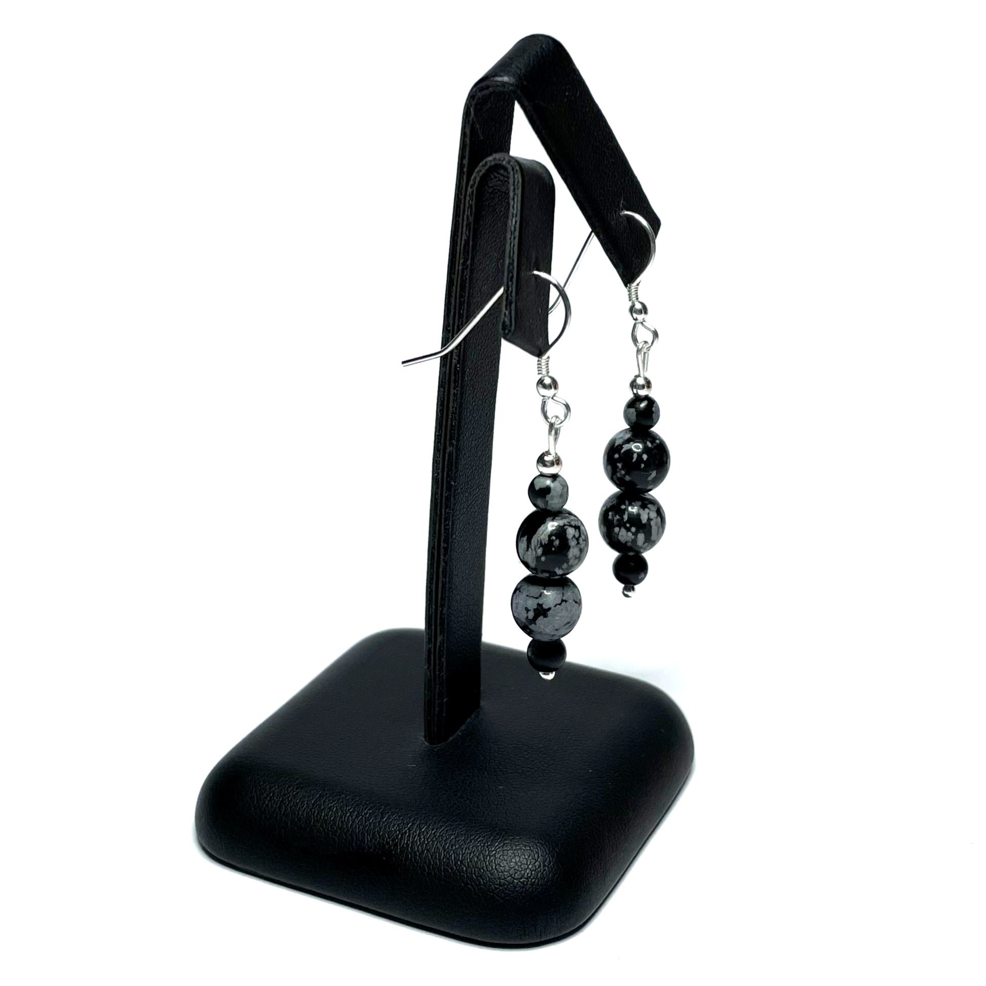 Snowflake obsidian crystal earrings on stand